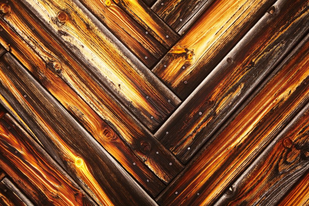 Water-damaged hardwood floor boards cupping at the edges.